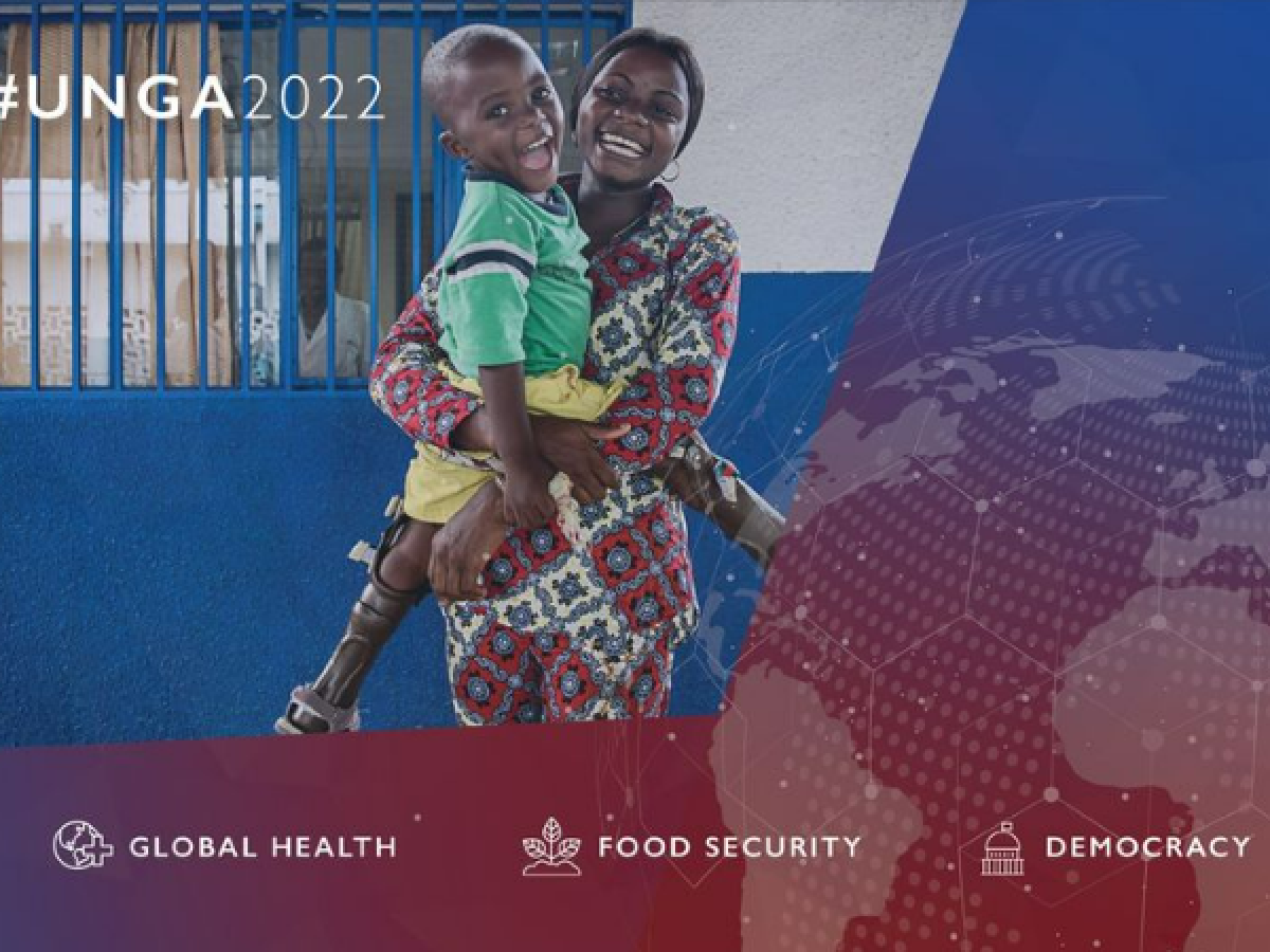 #UNGA2022 branded image of a woman holding a young child