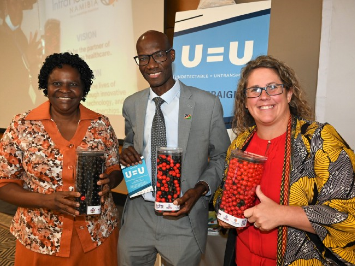 UNAIDS Namibia Director Dr. Alti Zwandor, Acting Health Ministry ED Jeremia Nghipundjwa and Acting USAID Namibia Representative Laura Muzart showcasing outreach tools that explain the meaning of “Undetectable = Untransmittable.”
