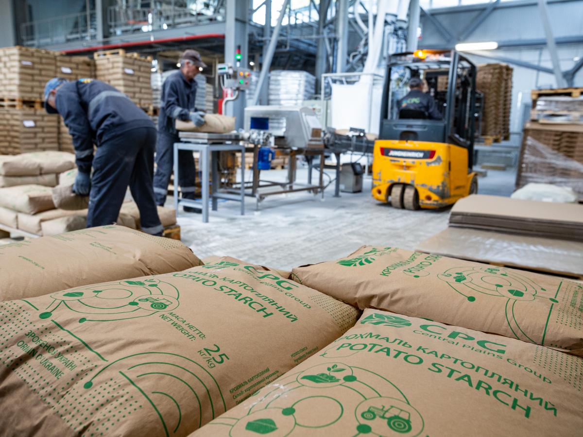 Large bags of potato starch lay on a factory floor.