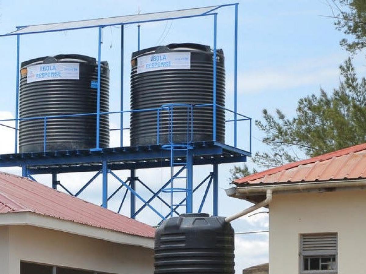 Two water tanks sitting above a hospital.