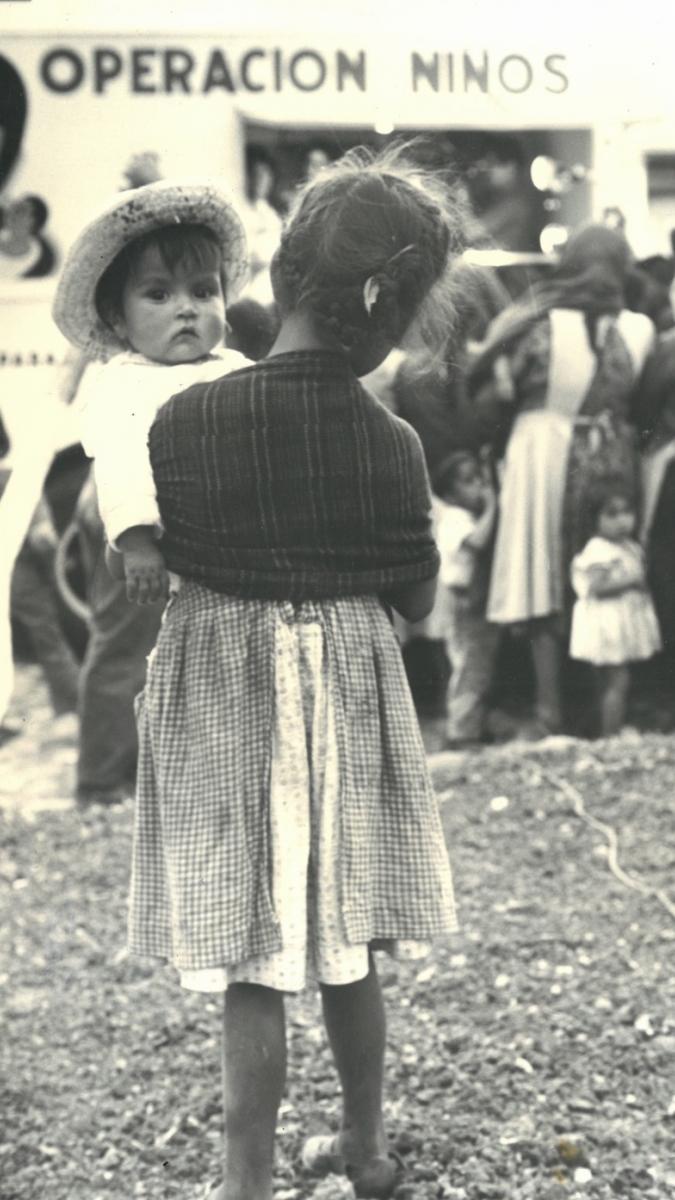 A historical photo of a woman holding a child