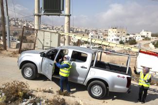 Rania Shamayla, Head of Subscribers Department at Electricity Distribution Company (EDCO), steps out of a truck to check a transformer in Kerak, Jordan.