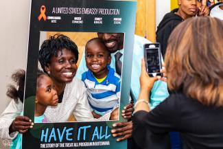A woman and her family pose for a photo at the premiere of "Have It All," a documentary produced by USAID and PEPFAR about five people in Botswana living full and productive lives on HIV treatment. 