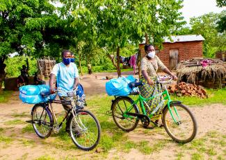 Community-Based Volunteers ride their bikes several kilometers to ensure each family receives their ITN.