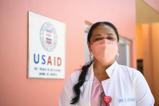 A Honduran woman wearing a face mask poses for the camera