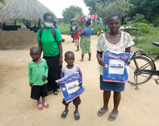 A family receives insecticide-treated bed nets in Lavushimanda District in Muchinga Province, Zambia