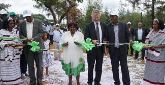 USAID and government officials and Bako Farm Service Center owner Alemitu Hordofa cut a ribbon to officially open the center.