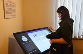 A woman explores a digital display at the media museum.