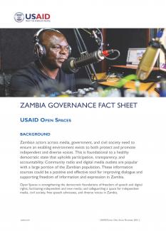 Thumbnail of 1st page of the USAID Open Spaces fact sheet shows a Zambian man in a radio studio wearing headphones and speaking into a microphone