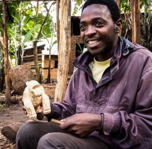 A Uganda man carves wooden gorillas for sale to visitors of the Bwindi Impenetrable Forest.