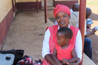 Setsabile and her baby Njabulo wait to receive food assistance through USAID partner World Vision.