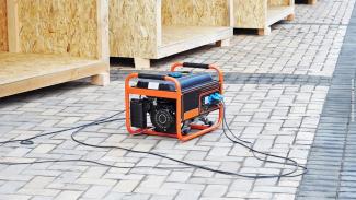 Photo of a portable backup generator at an outdoor construction site