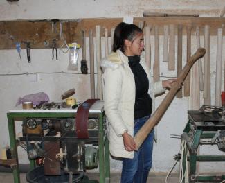 Dragana Stojinić in her workshop, where she crafts wooden handles for tools in Prijedor, BiH.