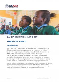 This thumbnail for the USAID Let's Read fact sheet shows a Zambian boy and girl in their school uniforms are engaged in lesson 
