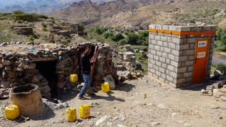 Mohsen proudly shows the newly constructed latrine next to his home. 