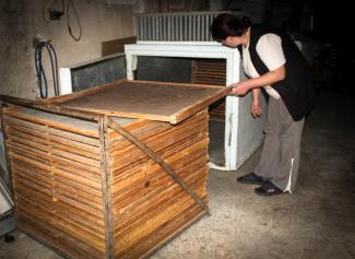 Vesna Budnjar monitors the progress of drying mushrooms and rosehips in a drying chamber in Kalinovik, Bosnia and Herzegovina.