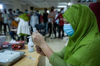 Image of vaccinator preparing Moderna COVID-19 vaccine in Bangladesh