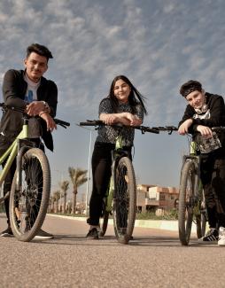 3 youth on bikes in Qaraqosh, Iraq 