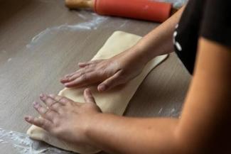 A woman's hands kneading dough.