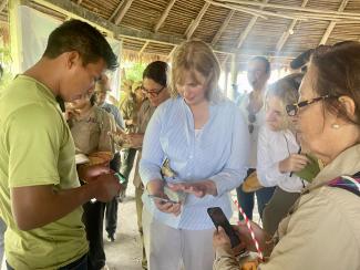 Indigenous People showing USAID Mission Director how they use technology to monitor their lands