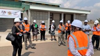 USAID Education Office Director Christine Veverka (L) addresses the Parliamentarians and Ministry of Education officials during the tour.