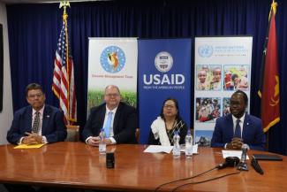 Four representatives from USAID and Papau New Guinea sitting around a table. 