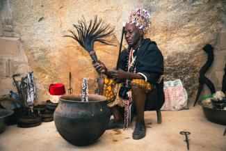 A traditional healer holds tools and instruments he uses for healing ceremonies.