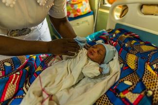 Adama observes a newborn baby boy her patient gave birth to just four hours prior.