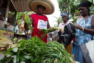 Christela sells produce at her market stand