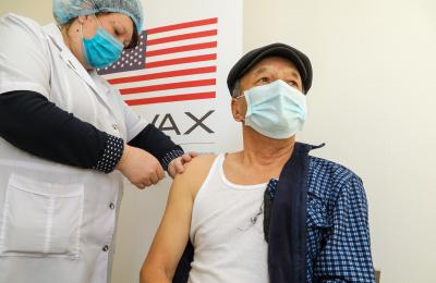 Man receiving COVID-19 vaccine. 