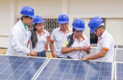 Youth in front of solar panels