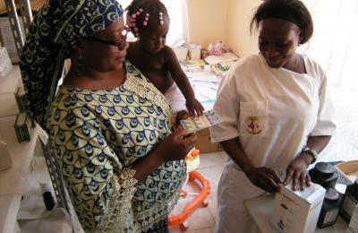 A mother and child receive medication in Angola