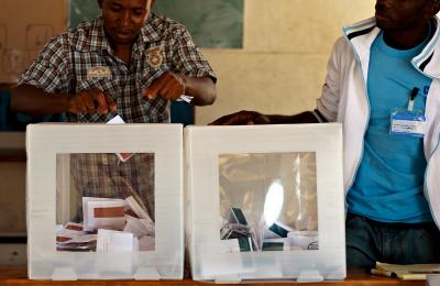 Two men attending a ballot box