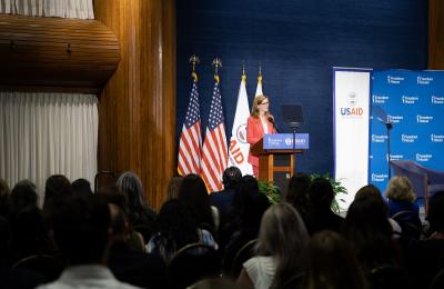 USAID Administrator Power delivers a speech in front of an audience.