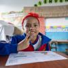 Migrant girl at a Peruvian school taking classes 