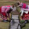 Two peasant women cleaning a water channel