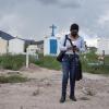 Esmeralda Sanchez checks her phone while at a cemetery she visited for an article she wrote.