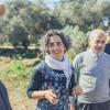 Ayala Noy Meir (left) and Khaled Hassan Hussein Yaseen Al-Juneidi (right) walk through an olive grove together.