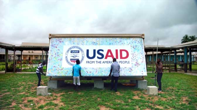 Men open up a USAID mobile laboratory